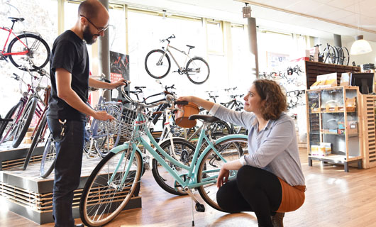 Vendeur de vélos et une acheteuse dans un magasin